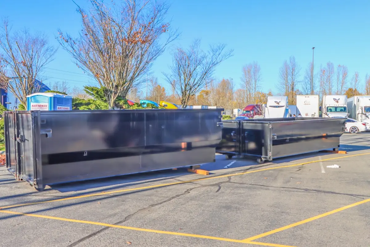 Professional dumpster rental service with roll-off container on residential driveway in Bernalillo